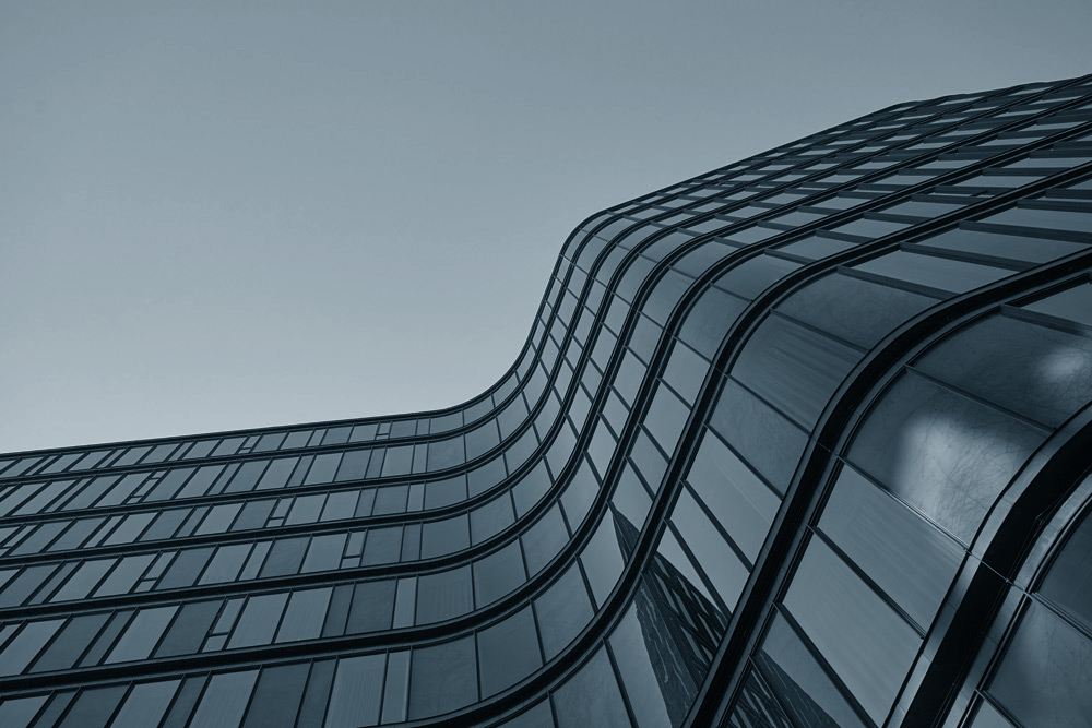 A curved building viewed from below upwards