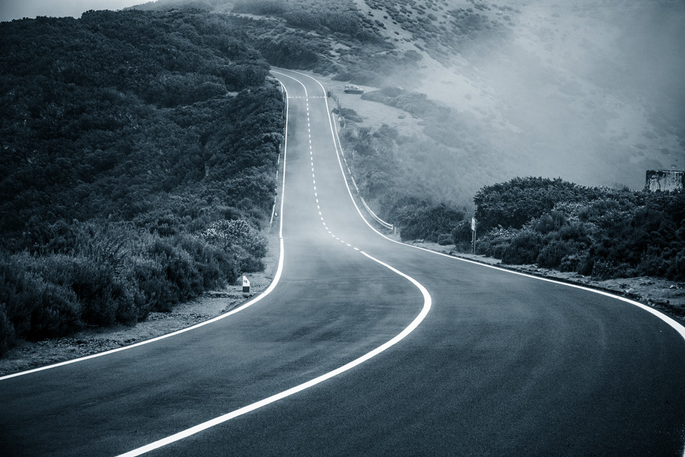 stock-photo-puzzled-businessman-standing-in-center-of-labyrinth-260065826_1000pxsquare winding-road