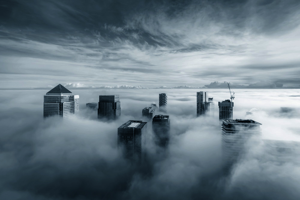 stock-photo-puzzled-businessman-standing-in-center-of-labyrinth-260065826_1000pxsquare Canary Wharf, London in fog